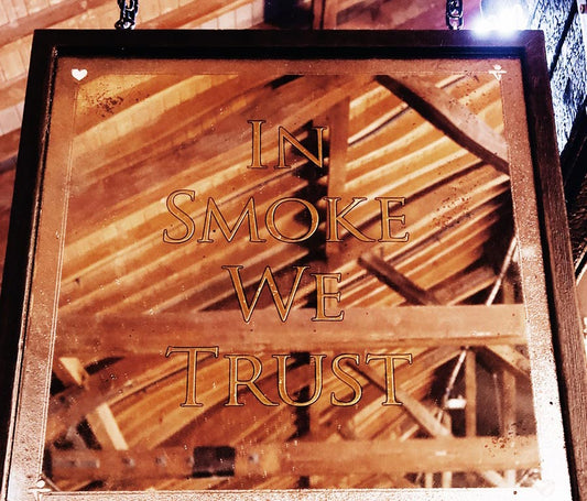 'In Smoke We Trust' hanging door sign
